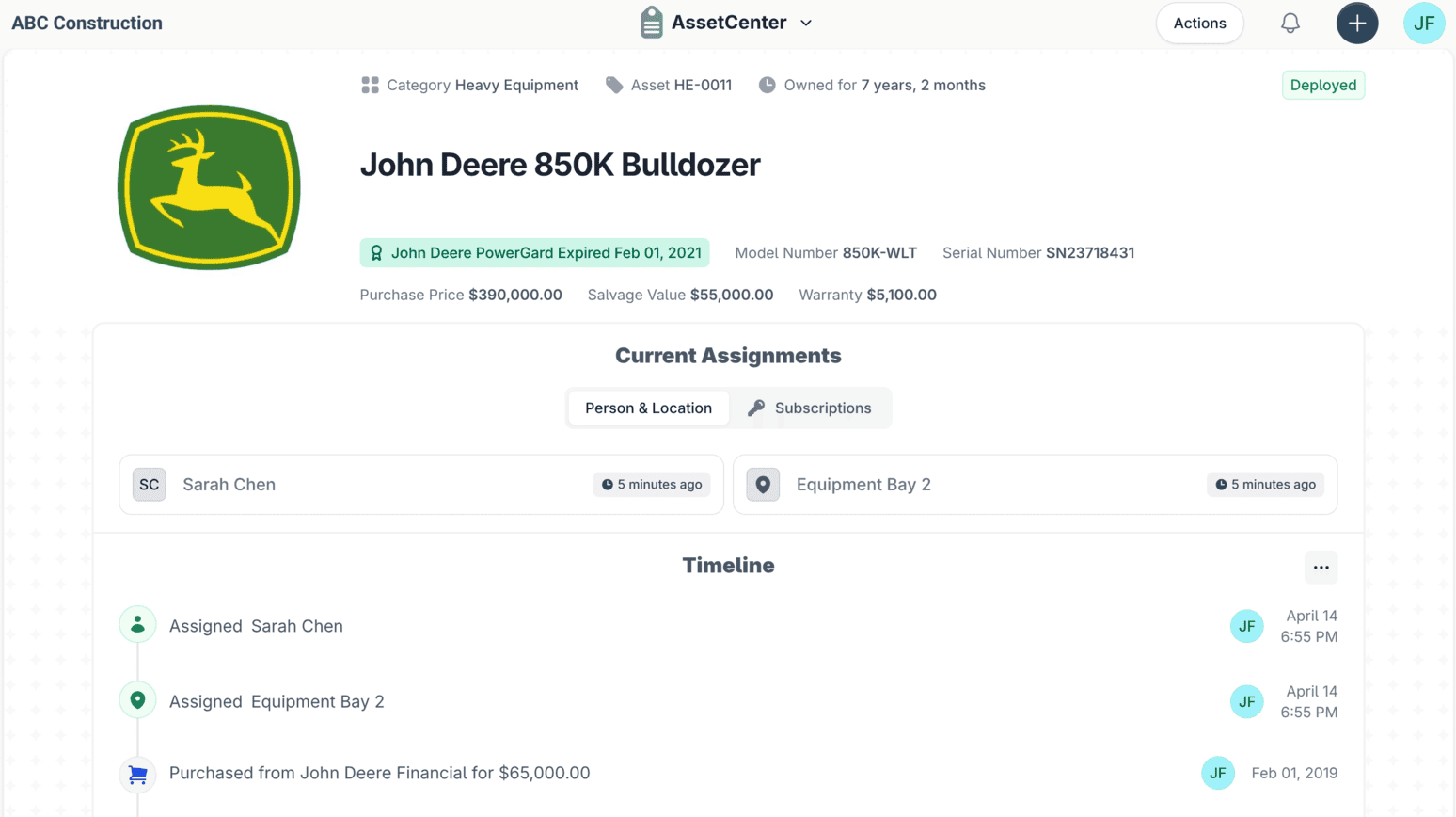 An asset record in AssetCenter for a John Deere 850K Bulldozer, showing its category, warranty and purchase figures, its current person and location assignments, and a timeline of assignment and purchase events.
