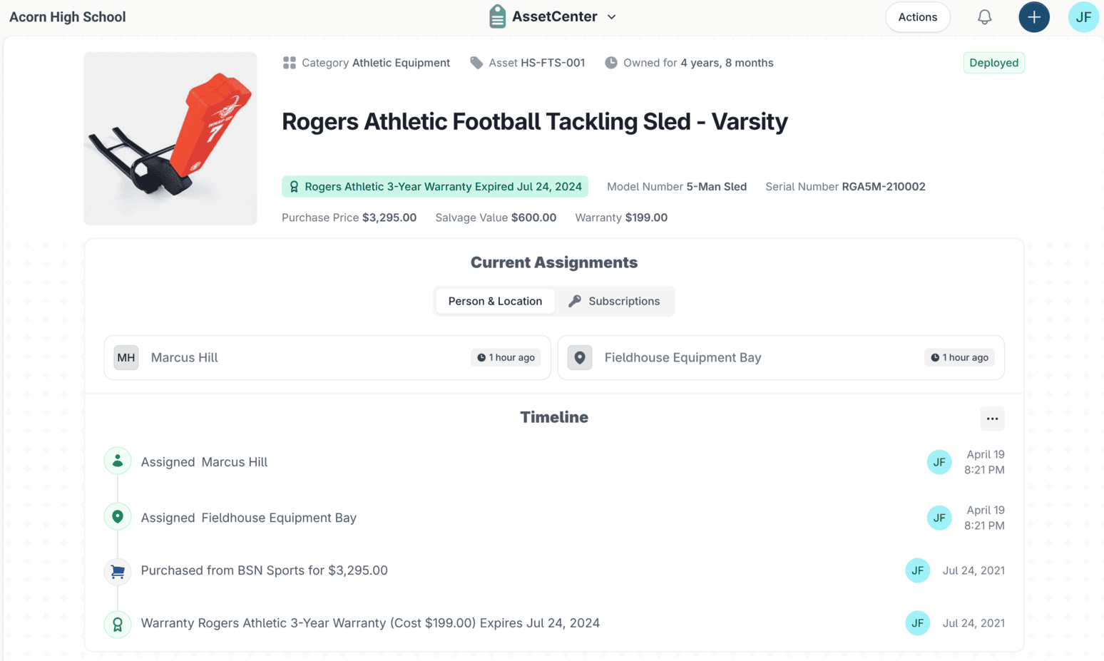 An asset record in AssetCenter for a Rogers Athletic Football Tackling Sled, showing its category, warranty and purchase figures, current assignments and a timeline of events.