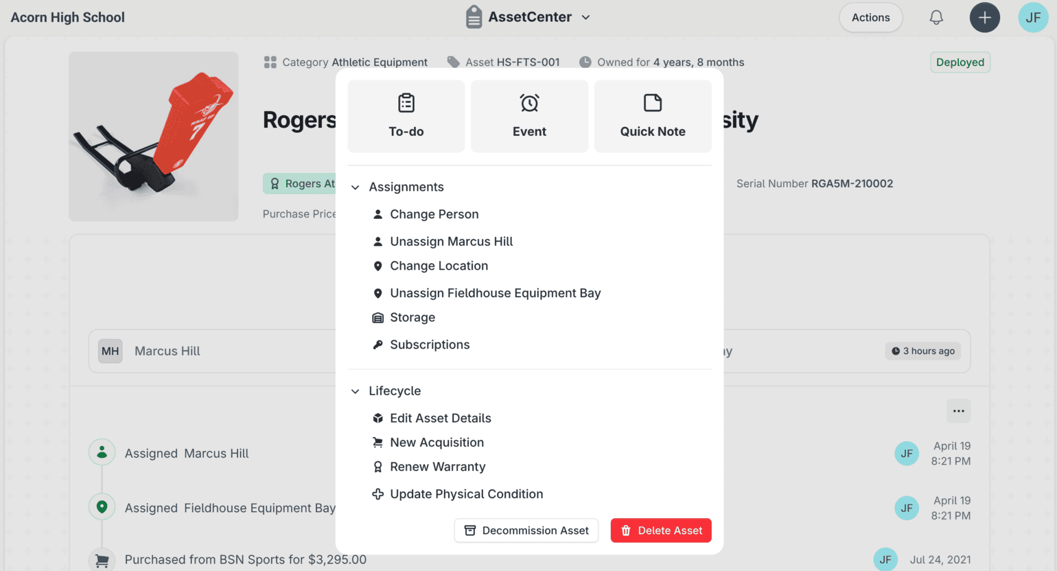 The actions menu open on a school asset record in AssetCenter, offering to-do, event and quick note shortcuts alongside assignment and lifecycle actions.